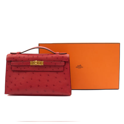 Hermes Mini Bag Kelly Pochette in Rouge Vif, Ostrich Leather — Lifestyle View